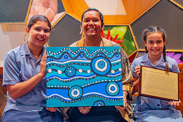 Students from St Mary’s Catholic Primary School with the AJA art work. Tilly (left) and Mia (right) with Minister Selena Uibo.