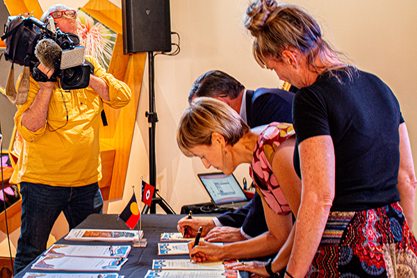 Signing the Aboriginal Justice Agreement Michael Gunner, Deborah Di Natale and NAAJA Chief Executive Officer Priscilla Atkins.